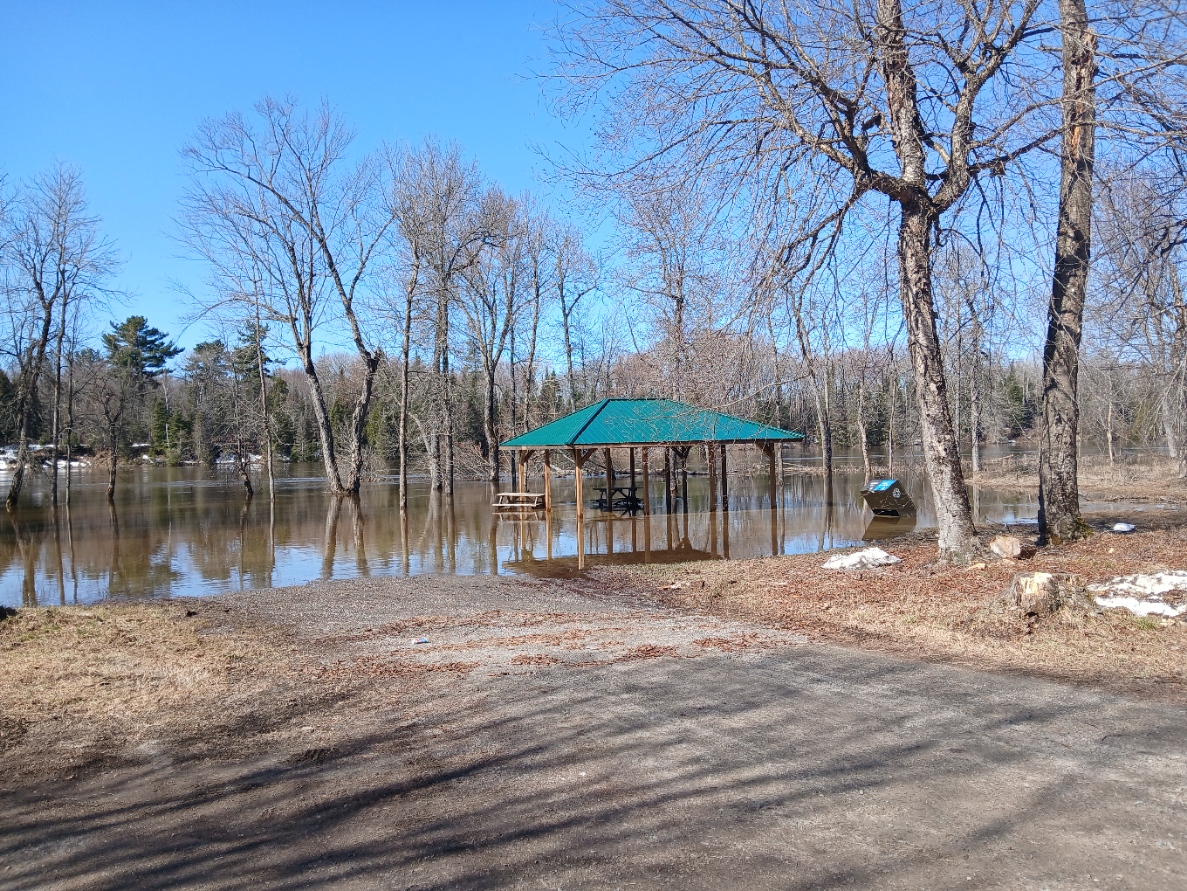 Community flood response along roads and shoreline — photo refreshed April 22, 2026.